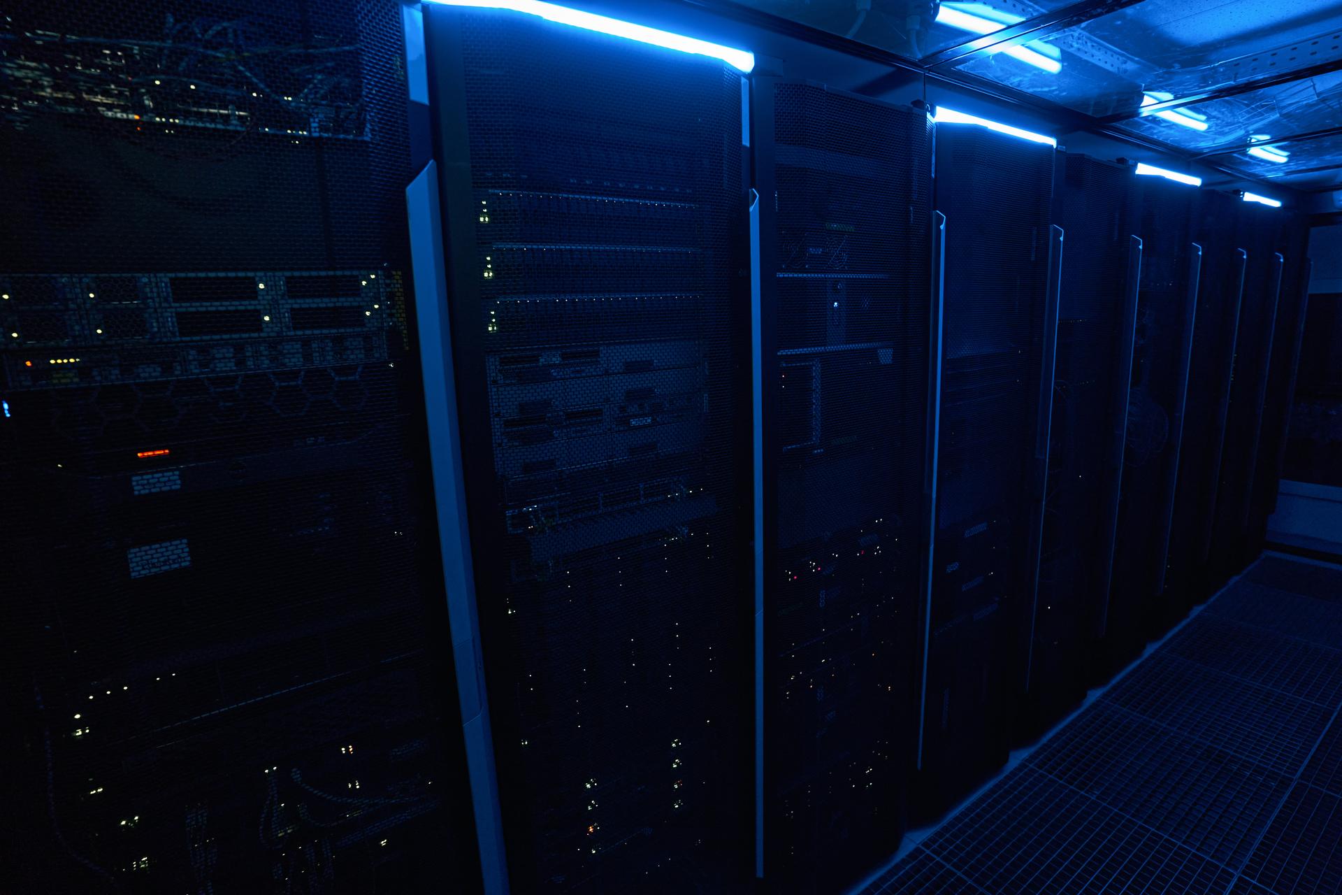 Row of illuminated server cabinets in a data center