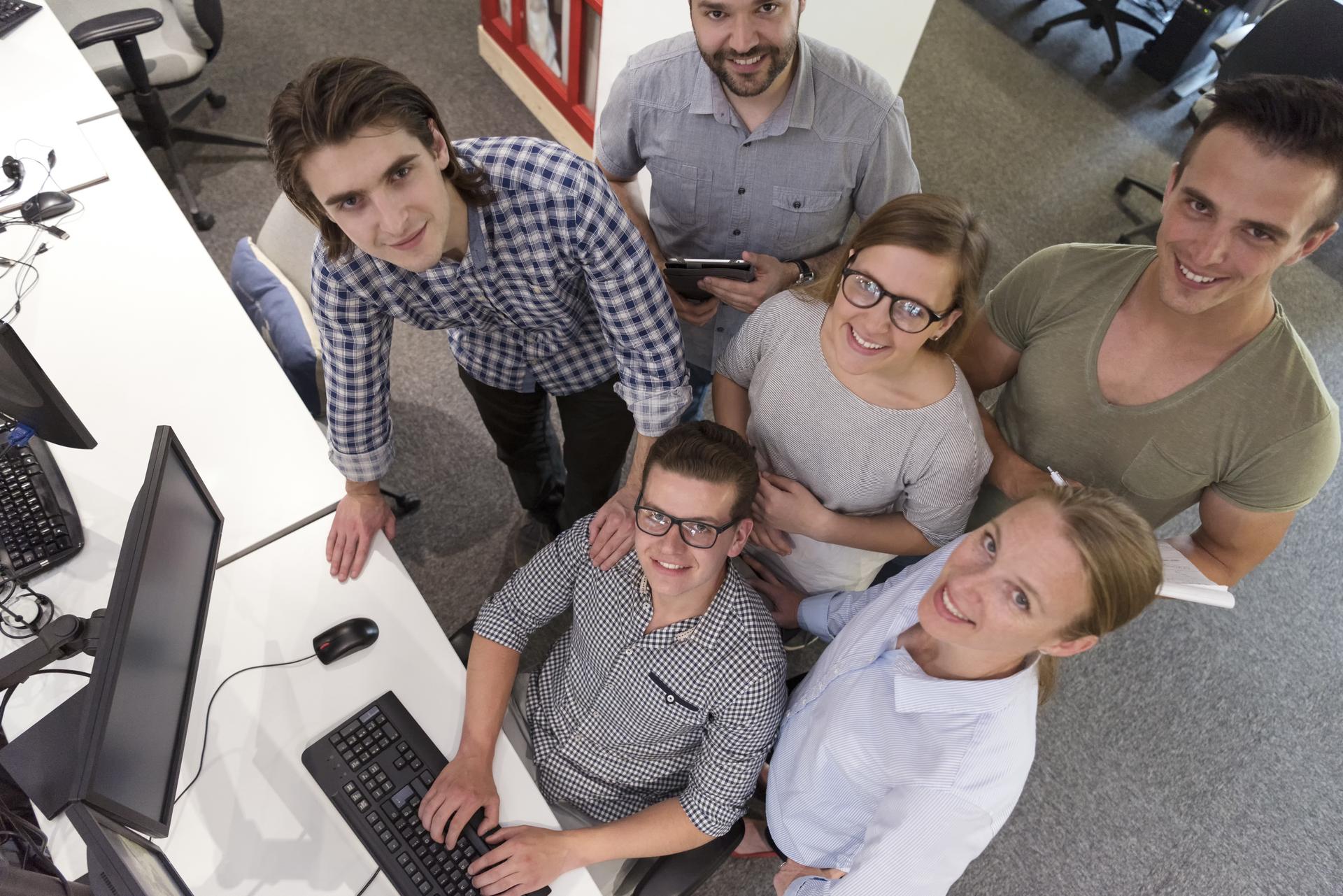 Quadex team members collaborating in an open office